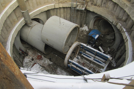 Concrete sewer pipe set inside a lined shaft